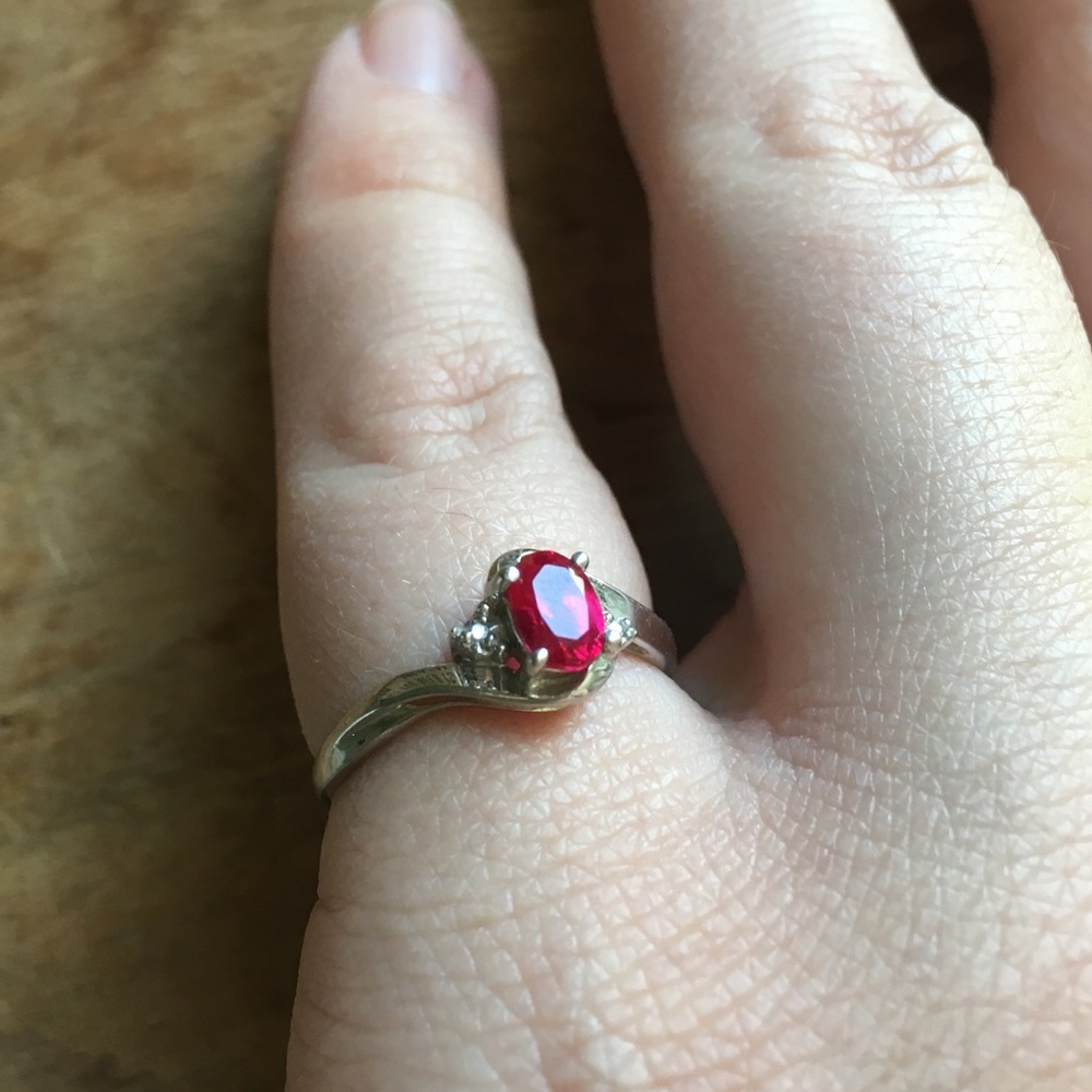 10k white gold, ruby ring with diamond accents.